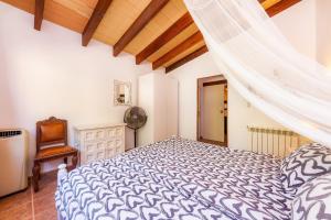 a bedroom with a bed and a wooden ceiling at Apartment Tina Capdepera in Capdepera +14 photos