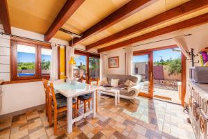 a living room with a table and chairs at Apartment Tina Capdepera in Capdepera