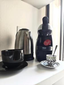 a counter with a coffee maker and a cup on it at Casa Vela in Riva del Garda