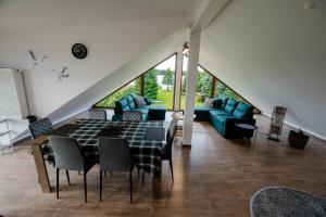a living room with a table and a couch at VISTA Necko - apartament nad jeziorem Augustów in Augustów