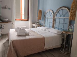 a bedroom with a large bed with two towels on it at Hotel Nice in Viareggio