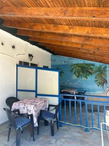 a table and chairs in a room with a ceiling at House Stamatis in Sarti