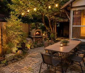 a patio with a table and a fire pit at 安樂-yasurai- in Otsu