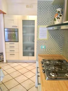 a kitchen with a stove and a counter top at Modì Apartment in Rome