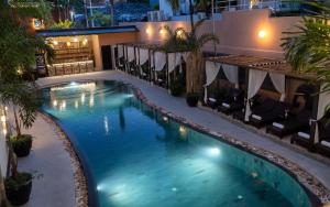 a swimming pool in a hotel at night at The Palace Indochine Hotel in Siem Reap