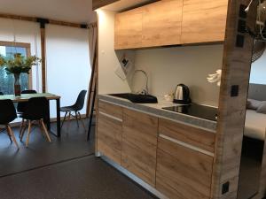 a kitchen with a sink and a table in a room at Villaggio La Pescaccia in San Clemente