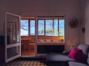 a living room with a couch and a large window at La finestra sul Matese in San Massimo