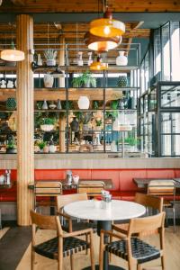 a restaurant with two tables and chairs and plants at The SPACE To Stay Aparthotel in St. Andrews