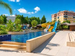 a pool at a resort with slides at Maxihomes Snitch in Kemerağzı