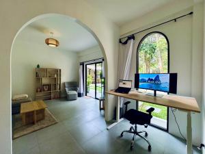 a room with a desk with a computer on it at Shanti Rock Residence Koh Phangan in Ko Kong Nui