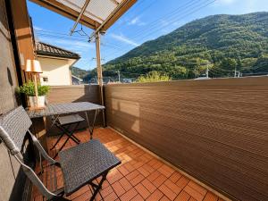 a balcony with a table and chairs and a fence at にし阿波ねすと in Higashimiyoshi