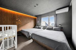 a bedroom with two beds and a window at The Lavenridge in Nakafurano