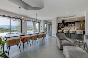 a dining room with a long table and chairs at Villa Casara Design and Relax Lago di Garda in Costermano