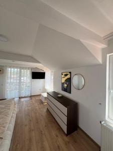 a living room with a couch and a dresser at Hotel Palma in Novi Pazar