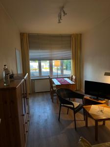 a living room with a table and a dining room at Landhaus Gerdts - 2 in Cuxhaven