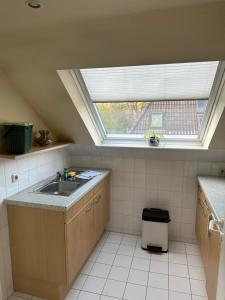 a kitchen with a sink and a window in it at Landhaus Gerdts - 2 in Cuxhaven +3 photos