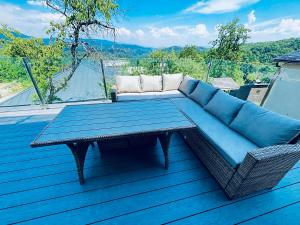 a blue couch and a table on a deck at Levander 2 in Králiky