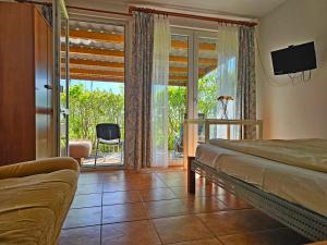 a bedroom with a bed and a sliding glass door at Pod Jesionem in Lubin