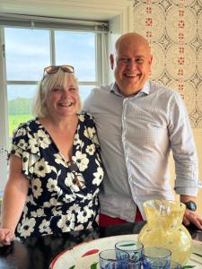 a man and a woman standing in front of a table at Tant Märtas rum & skafferi in Köinge