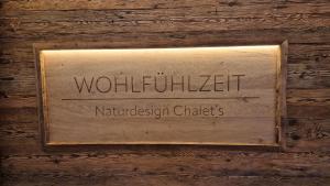 a sign on a wooden wall with the words wolfkritkritthalthalaughtersociation at Chalet Auszeit - Wohlfühlzeit Naturdesign Chalet`s in Rimbach +16 photos