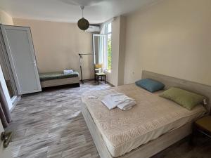 a bedroom with a bed with two towels on it at Kety House in Makhinjauri