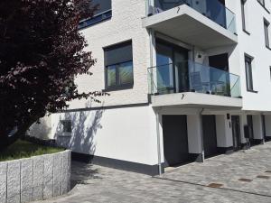 a white building with a balcony on the side of it at Wohnung in Dahme +3 photos
