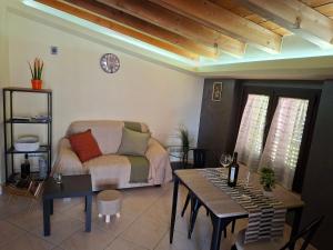 a living room with a couch and a table at LOCAZIONE TURISTICA Camere De Vito in San Salvo