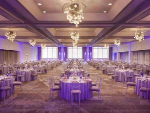 a large banquet hall with tables and chairs and chandeliers at Fairmont Dallas in Dallas +83 photos