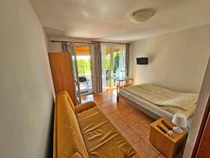 a living room with a couch and a bed at Pod Jesionem in Lubin