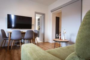 a living room with a couch and a table with chairs at Levander 2 in Králiky