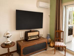 a living room with a tv on the wall at Flavia's House in Gaggi
