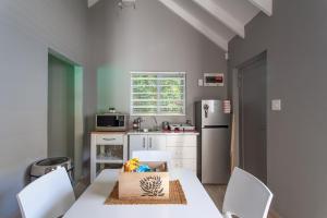 a kitchen with a white table with a box on it at The Barn Style Cottage in Cape Town
