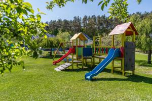 a group of playground equipment in a park at Domy Morskie Dog Friendly in Jantar +122 photos
