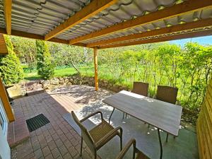 a patio with a table and chairs under a pergola at Pod Jesionem in Lubin
