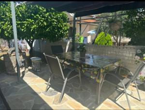 a table with two chairs and an umbrella on a patio at Agathe Haus in Stavros +7 photos