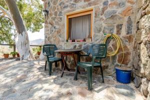 a table and chairs outside of a stone building at Tasarte by Villas Rivero in Tasarte