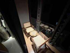 an overhead view of a table and chairs on a balcony at Copper Living in Muscat