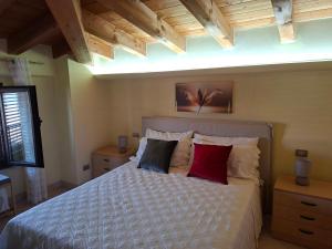 a bedroom with a bed with two red pillows at LOCAZIONE TURISTICA Camere De Vito in San Salvo
