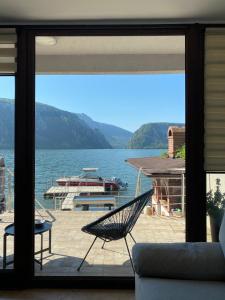 a room with a view of a lake with a hammock at Casa Maria Dubova in Dubova +12 photos
