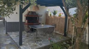 a patio with a table and chairs under an umbrella at Agathe Haus in Stavros