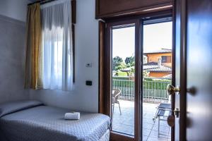 a bedroom with a bed and a sliding glass door at River Hotel in Castel di Sangro