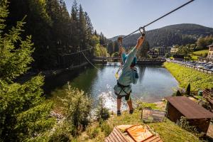 a person is hanging on a rope over a river at Residence Riverside in Pec pod Sněžkou +32 photos