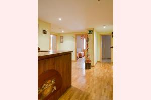 a kitchen and living room with wood flooring at Hostal Valle De Tena in Sabiñánigo