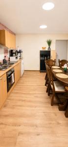 a kitchen with a table and chairs in a room at Puhkepesa 6 in Otepää