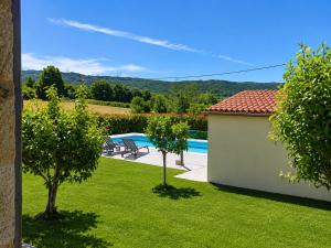 a view of a yard with a pool and trees at Casa Ravel in Silleda