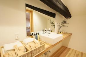 a bathroom with a white sink and a mirror at 古民家宿THYME（タイム） in Ōno +34 photos