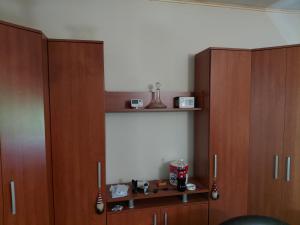 a room with three wooden cabinets and a shelf at Marinel in Vršac