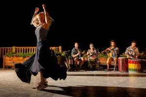 a woman is dancing on a stage with a band at Briaa Wellness Resort Hotel Gilboa - Adults Only in Maalé-Hagilbo‘a +81 photos