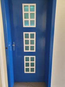 a blue door with windows in a room at Mesta Room in Gotse Delchev