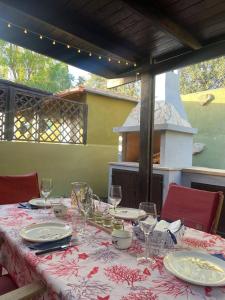 a table with plates and glasses on top of it at Villa Celeste in Torre delle Stelle +3 photos
